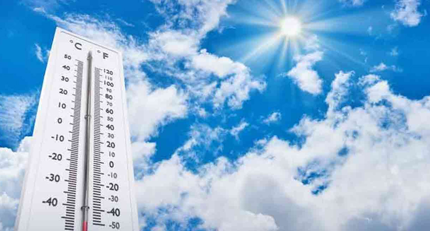 A thermometer under a bright, sunny sky with clouds.