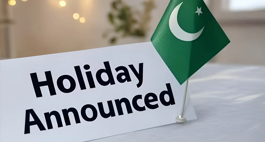 A small Pakistani flag stands next to a white card reading 