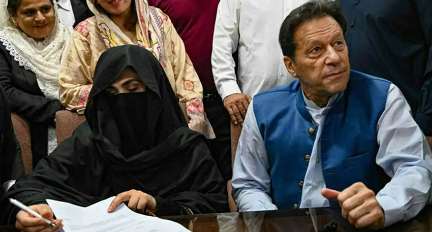 Imran Khan and Bushra Bibi sitting together at a desk.