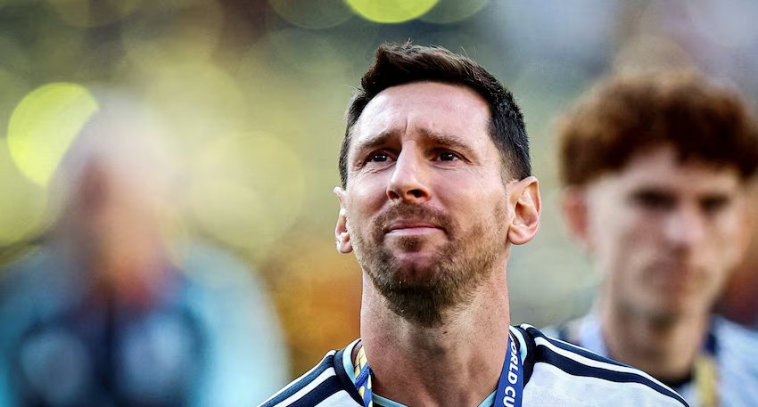 Close-up of Lionel Messi looking emotional in his Argentina jersey.