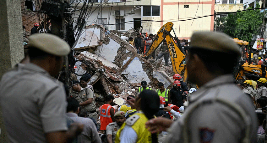 Rescue teams search rubble after a deadly building collapse in Delhi